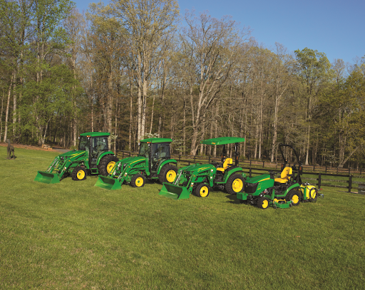  John Deere tractors lined up along the fence