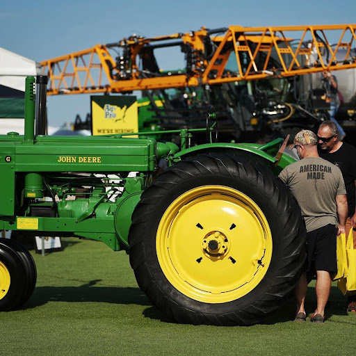 Green John Deere equipment at the Ag-Pro Presentation Tent