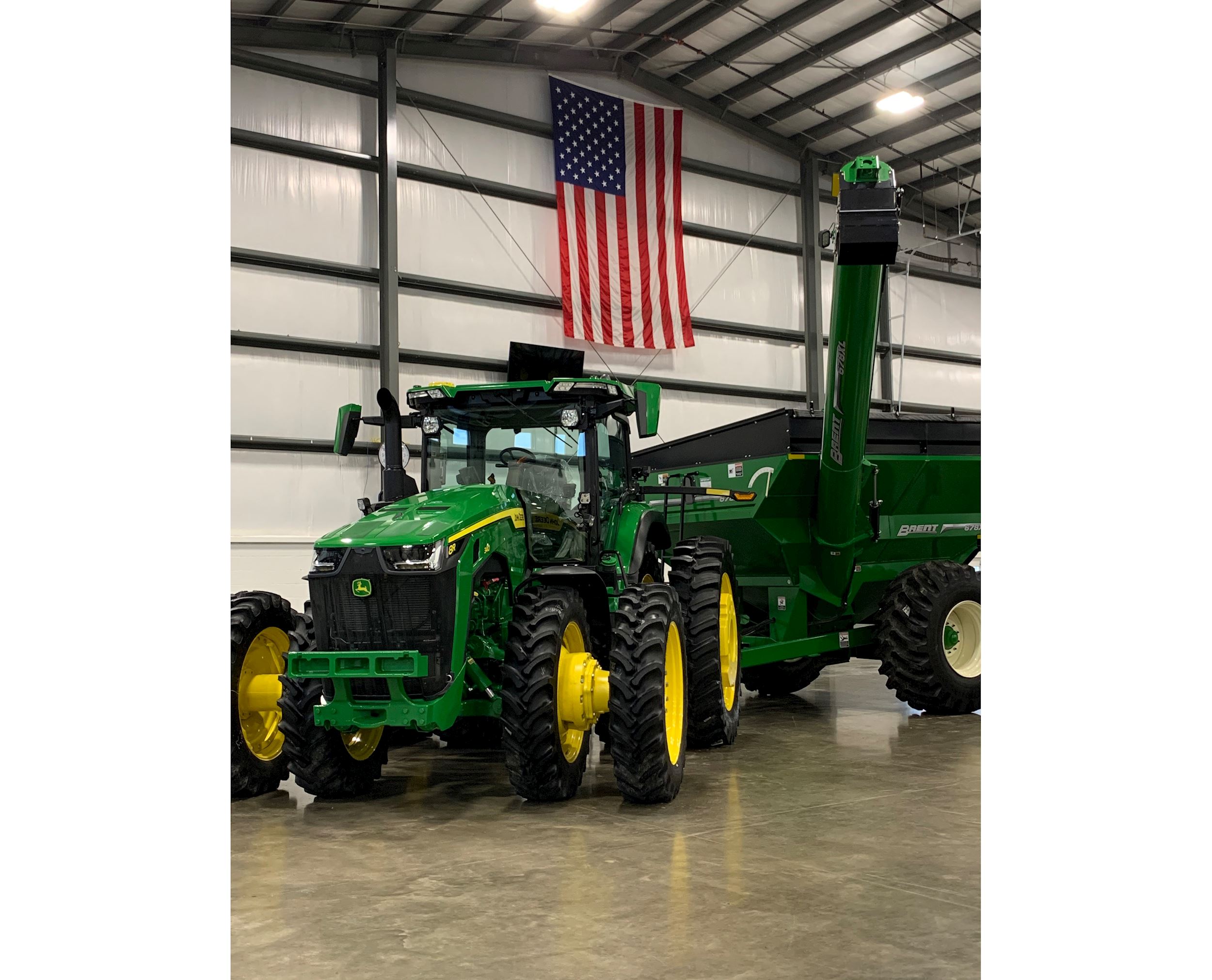 An American flag hangs behind a John Deere tractor at an Ag-Pro shop.