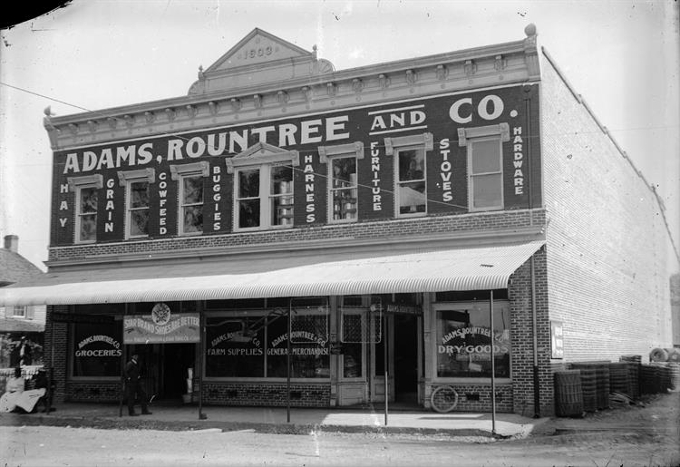 A black & white image of the former Adams, Rountree and Co. building in Boston, Georgia.