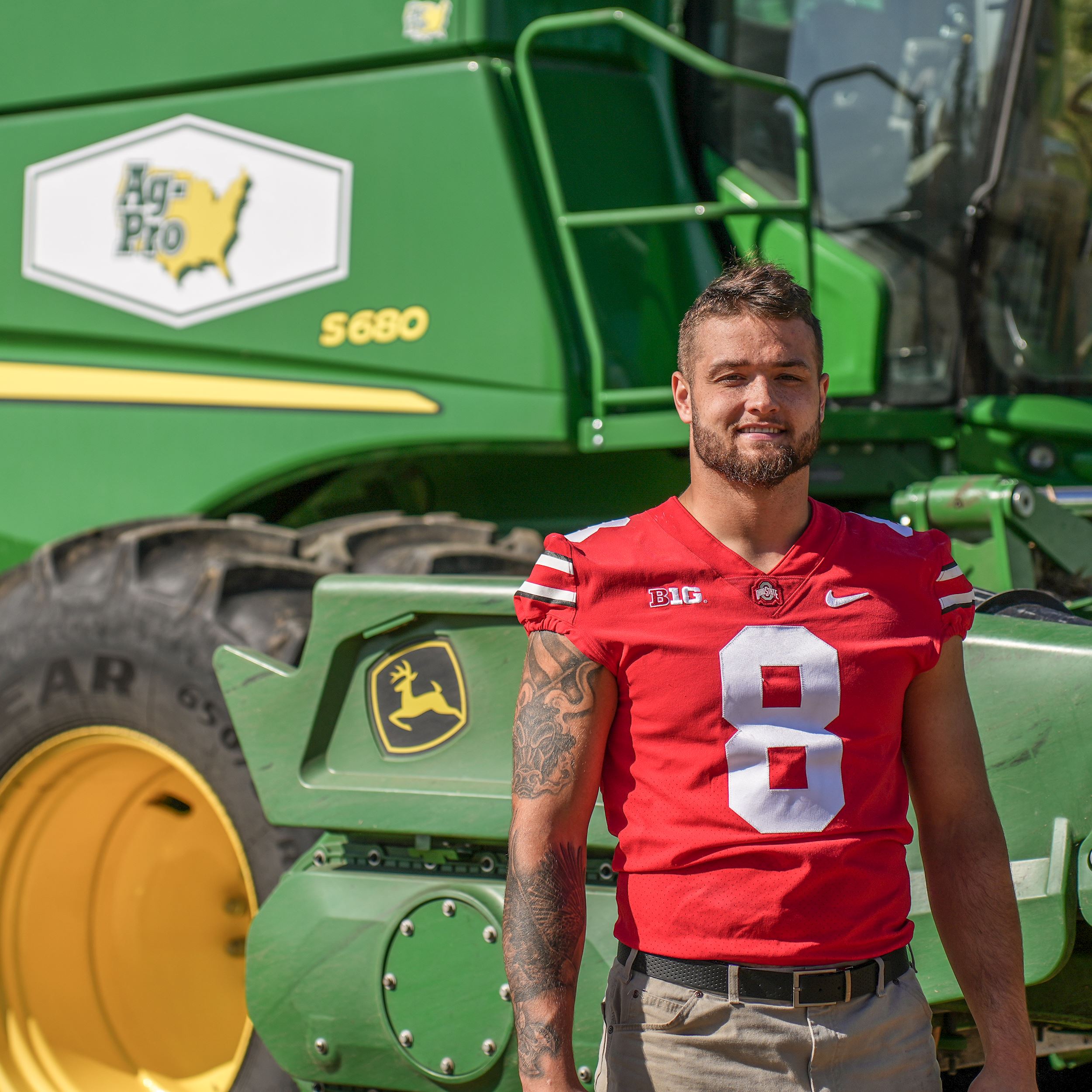 Cade Stover standing in front of a tractor from Ag-Pro
