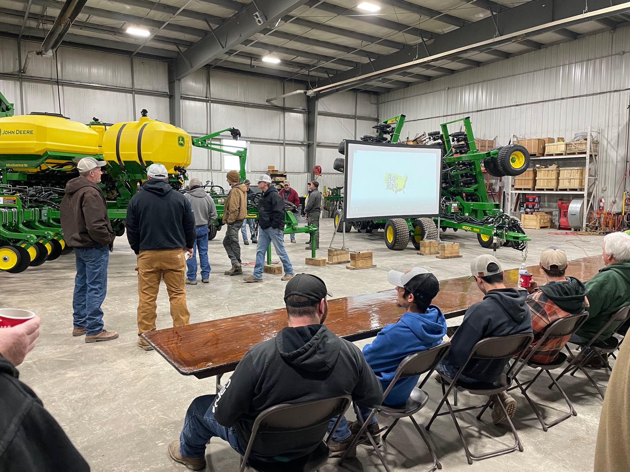 Customers gather around a presentation screen for Ag-Pro's Ohio Spring Clinics.