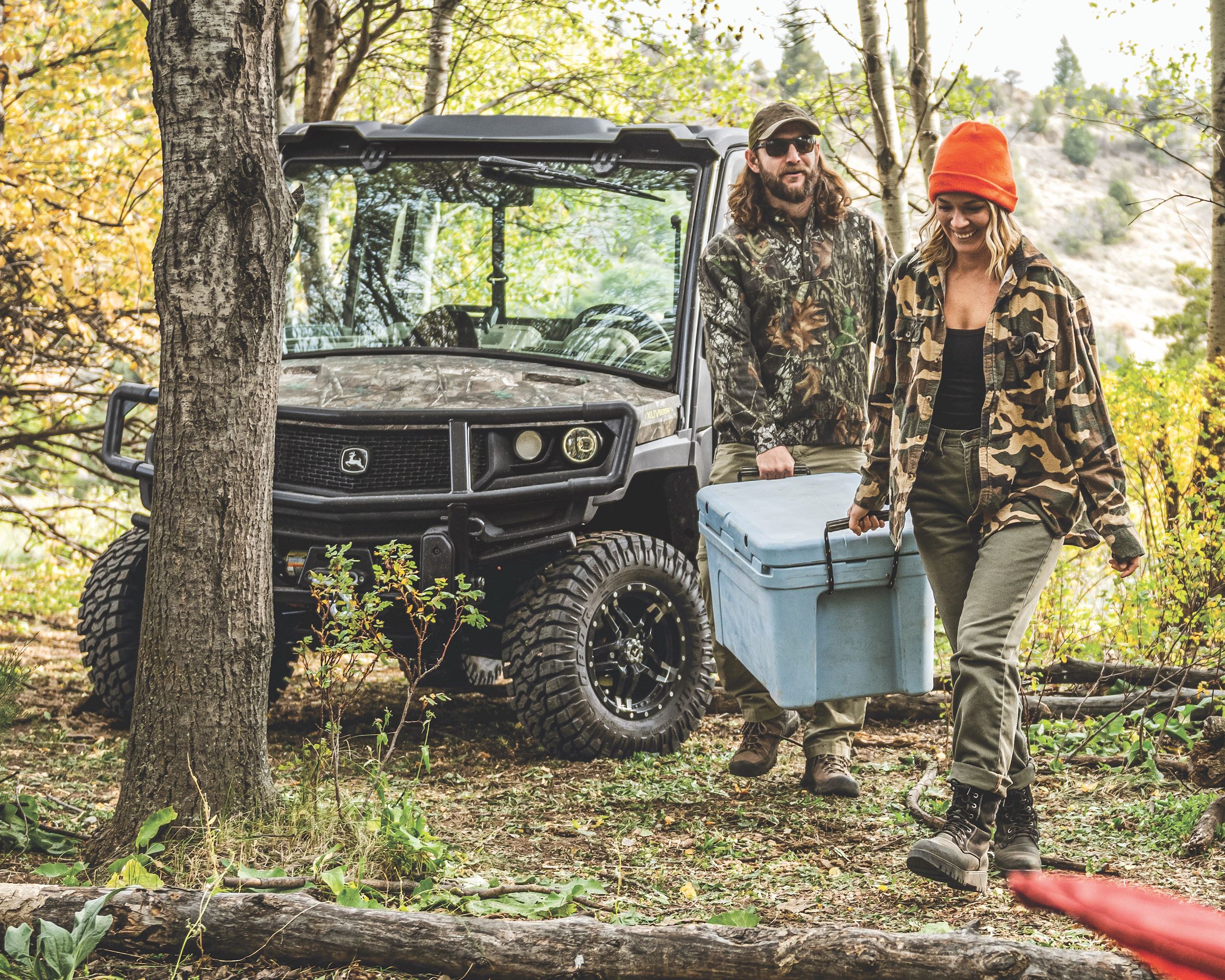 Man and Women using John Deere Gator