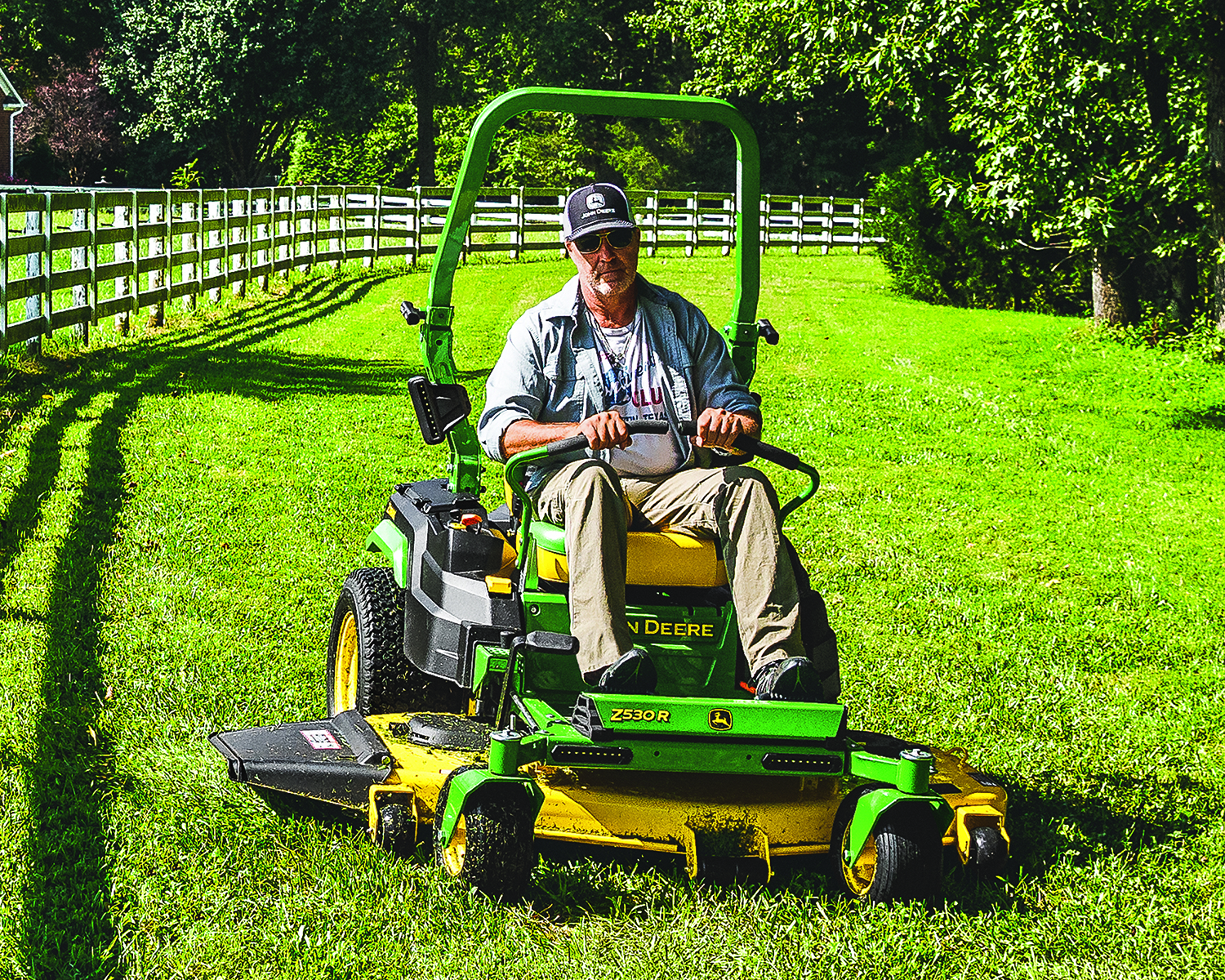 Man mows the grass using a John Deere Z530R Zero-Turn mower.